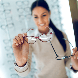 woman holding two eyeglass frames
